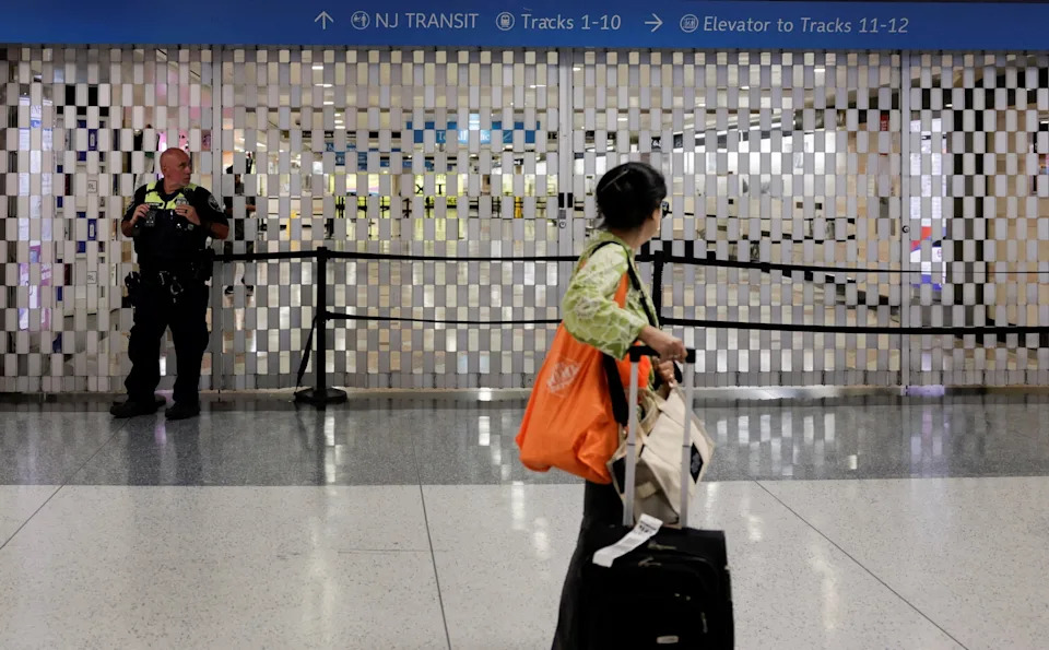 Jeenah Moon/Reuters - PHOTO: A woman walks at the station after reports of a stabbing incident at Penn Station in New York City, U.S., June 7, 2026.