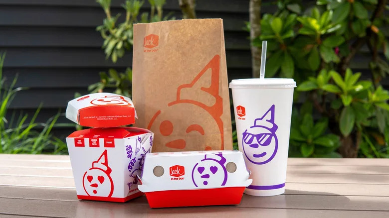 A Jack-in-the-Box meal sits on a picnic table outside.