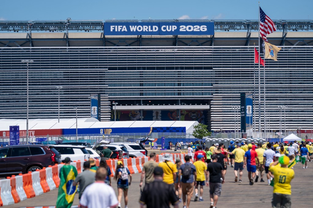 Fans walking towards the FIFA World Cup 2026 stadium.