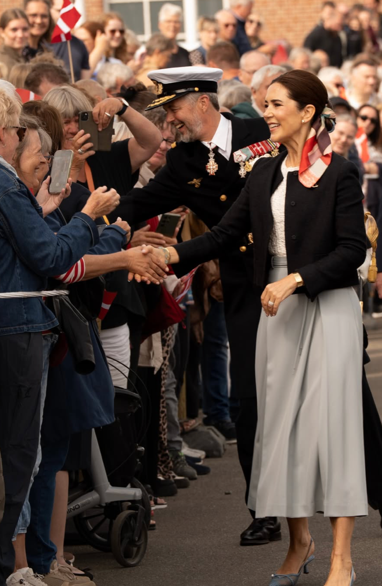Queen Mary elevated her nautical-inspired look with a vibrant silk scarf woven into her sleek chignon while sailing aboard the historic Dannebrog.