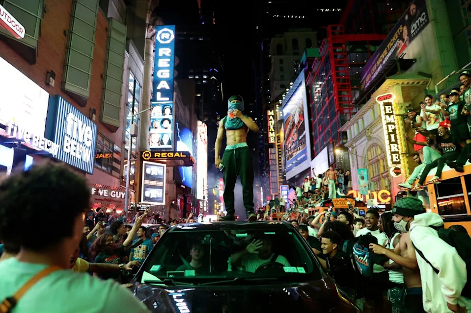 A person stands on top of a car as thousands of Knicks fans flooded the streets of NY after the team’s win. AP Photo/Heather Khalifa