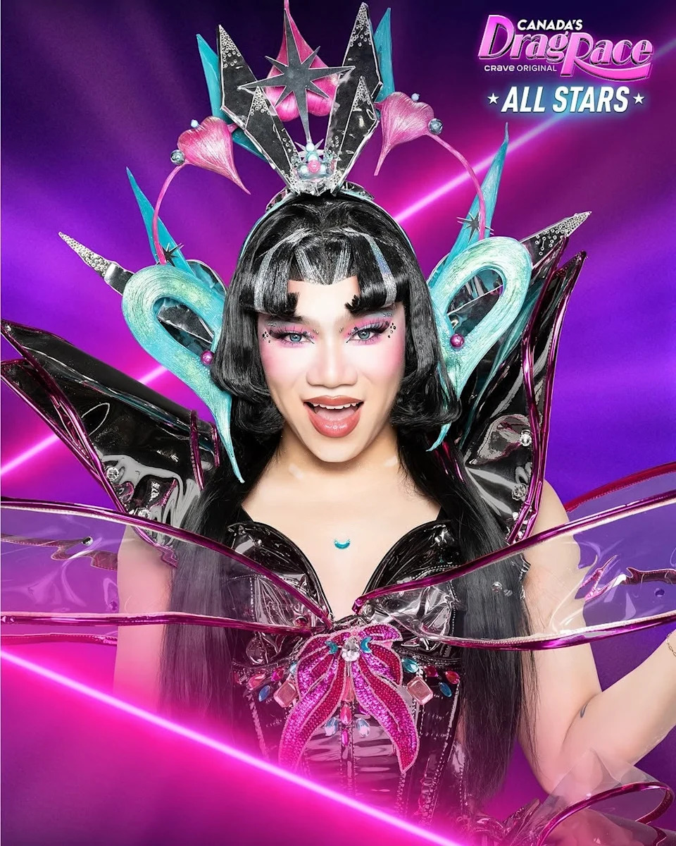 Person in elaborate futuristic costume with large headpiece, posing energetically. Appears in promotional image for "Canada's Drag Race: All Stars."