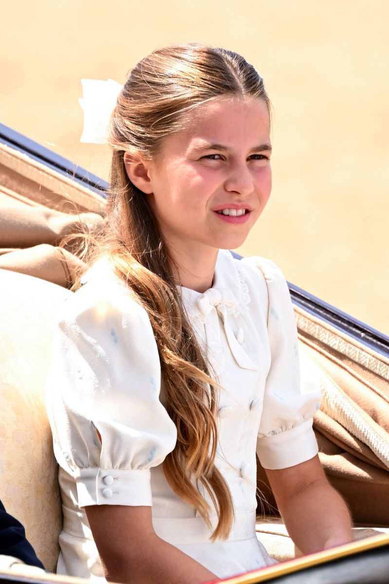 Princess Charlotte coordinated with her mother, Kate Middleton, in an elegant white dress, completing the look with a matching hair bow as she joined the royal family for Trooping the Colour 2026.