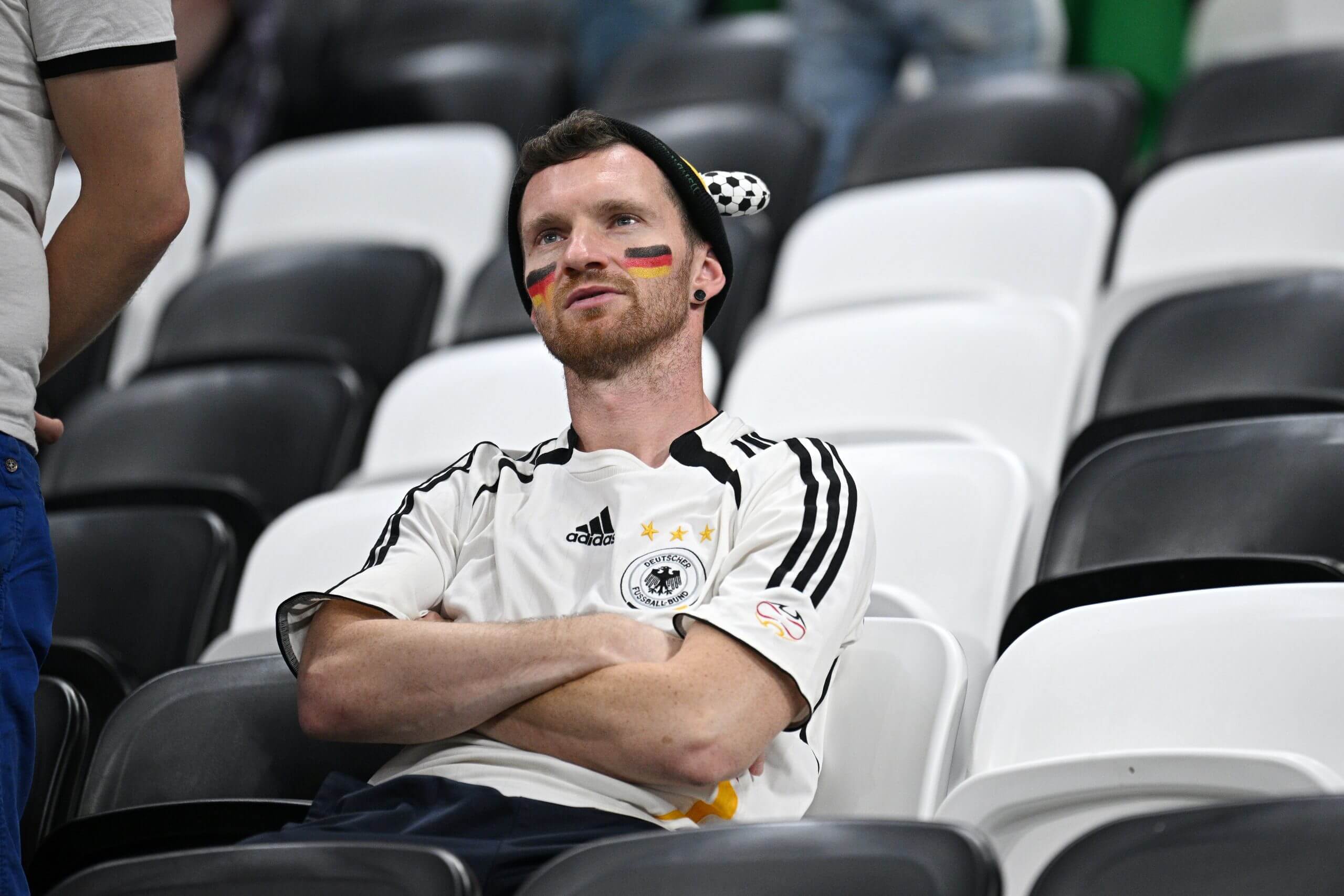 A Germany fan looking sad with his arms crossed
