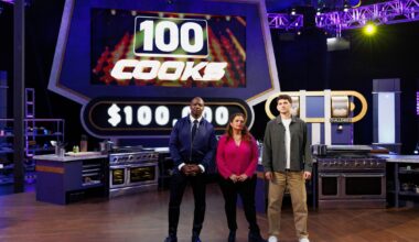 Host Terry Crews with Judges Alex Guarnaschelli and Nick DiGiovanni posed in front of LED board, as seen on 100 Cooks, Season 1.