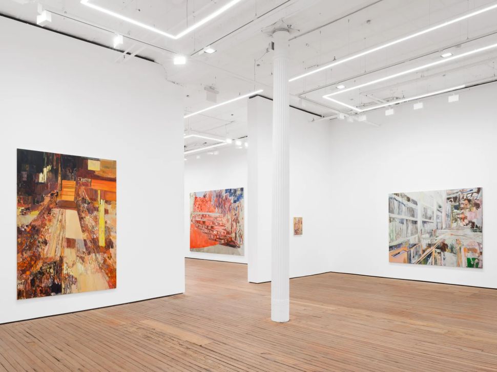 An installation view of Francesca Mollett’s “Buried Shadow” at GRIMM New York shows large abstract paintings hung across white gallery walls, with wood floors, high ceilings, bright linear lights and a central white column.