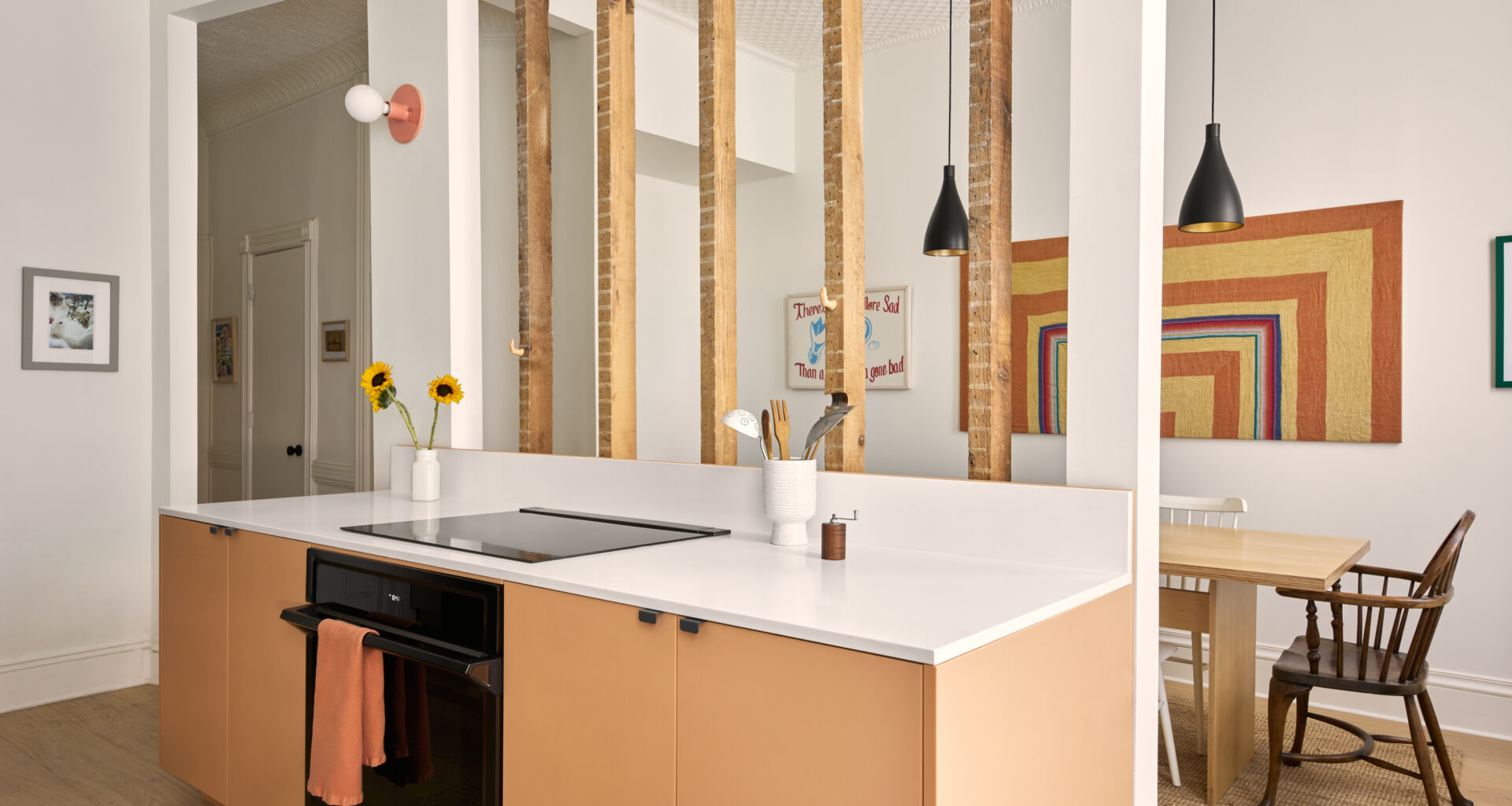 KITCHEN COUNTER WITH RAW JOISTS DINING ROOM IN BACKGROUND