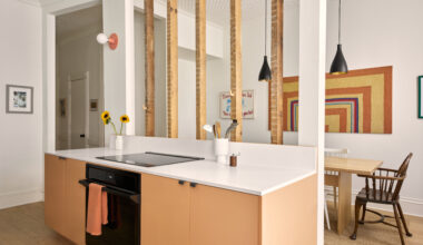 KITCHEN COUNTER WITH RAW JOISTS DINING ROOM IN BACKGROUND