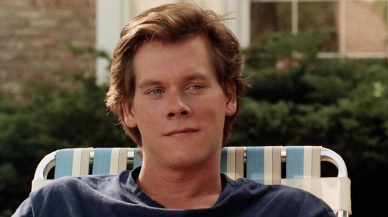 Kevin Bacon reclines on a lawn chair as Jake Briggs in She's Having a Baby