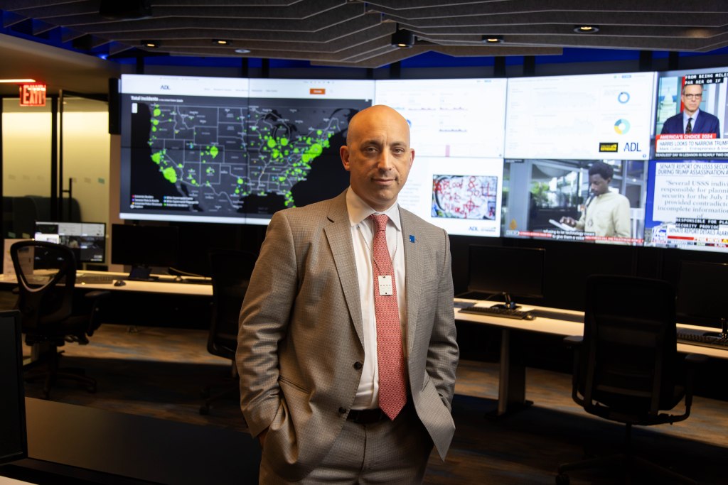 Jonathan Greenblatt, National Director and CEO of the Anti-Defamation League, stands in the ADL Investigative Research Lab, with screens displaying data related to extremism and hate incidents.
