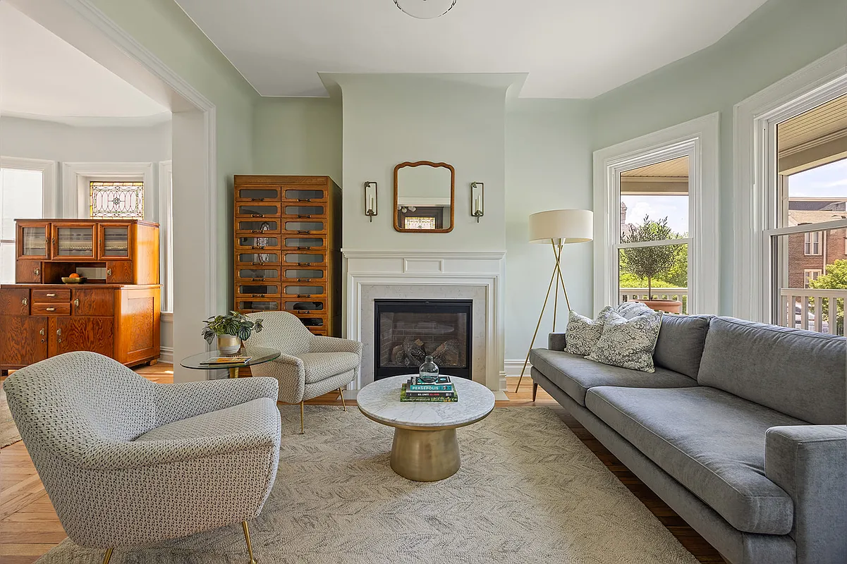 living room with mantel, wood floor