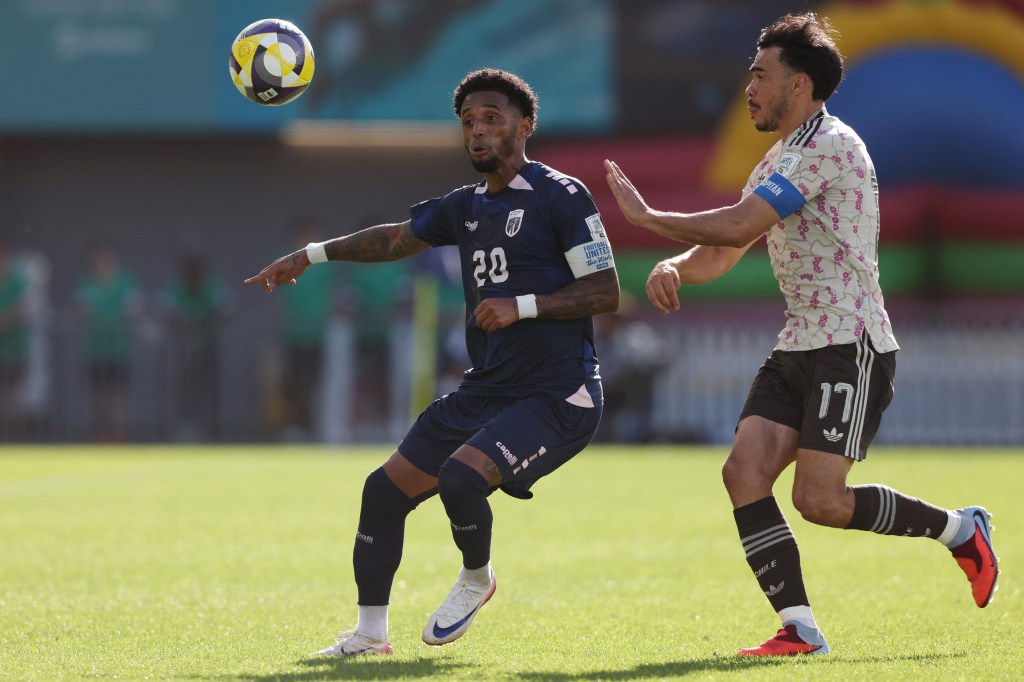 Ryan Mendes of Cape Verde (L) kicks the ball during an international friendly football match between Chile and Cape Verde in Auckland.