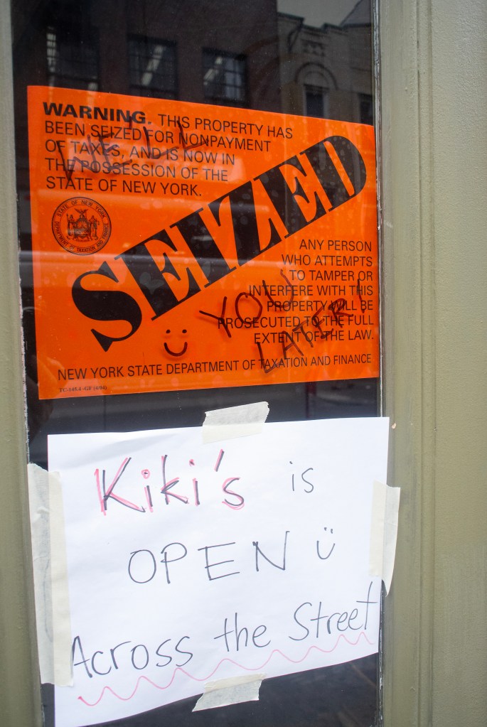 A sign outside Kiki's announcing it was seized.