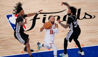 New York Knicks guard Jalen Brunson (11) drives past San Antonio Spurs defenders during the second half of Game 3 of the NBA Finals basketball series, Monday, June 8, 2026, in New York. (AP Photo/Yuki Iwamura)