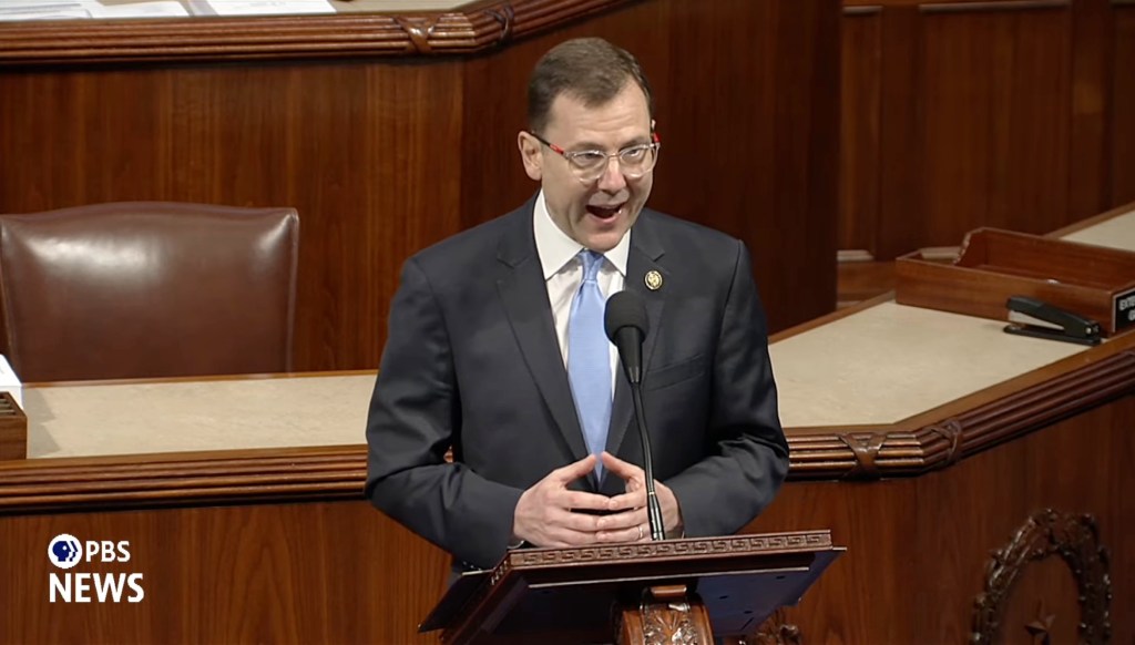 Rep. Tom Kean Jr. speaking at a podium on the House floor.