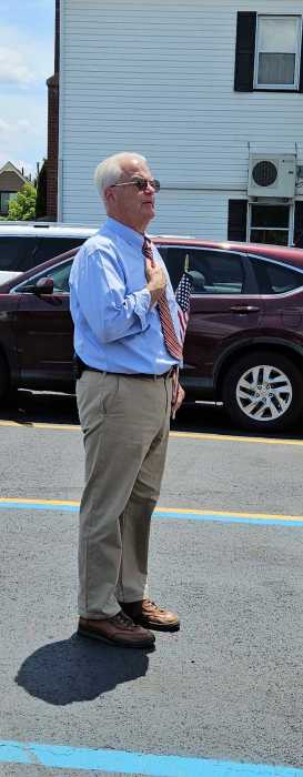 man standing in front of a car in business attire