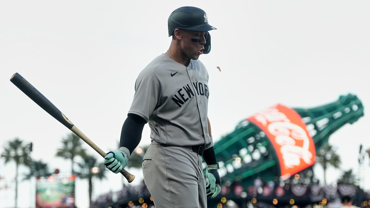 Aaron Judge walking to dugout after striking out during baseball game
