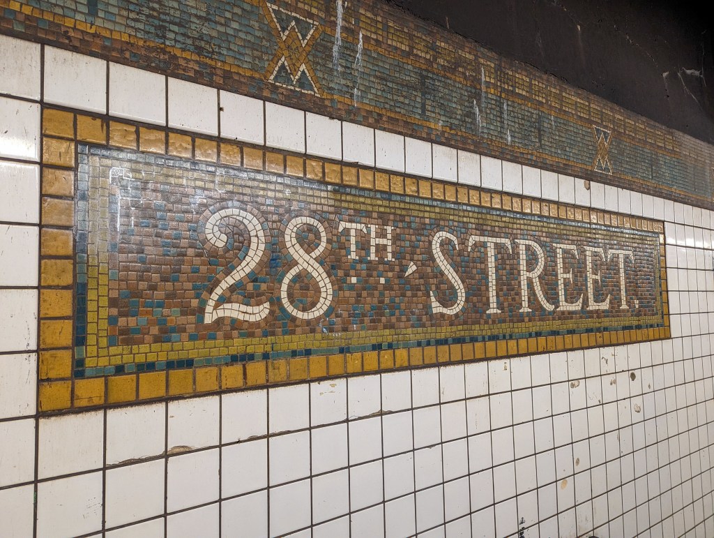 Mosaic subway sign for 28th Street Station in New York City.