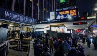 Fans line up outside Madison Square Garden for an NBA basketball game between the New York Knicks and the Golden State Warriors in New York, Tuesday, Feb. 23, 2021.