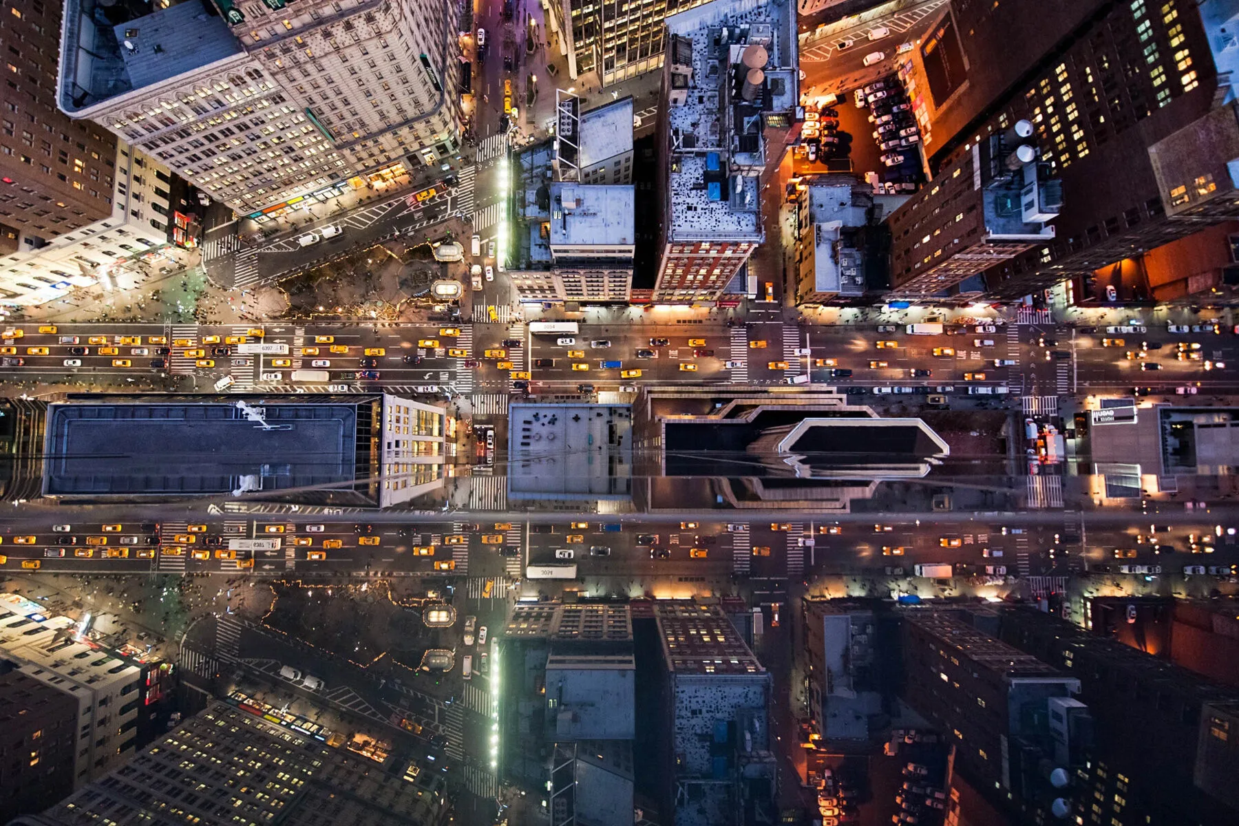 Photographic artwork shows cityscape reflecting in glass surfaces.