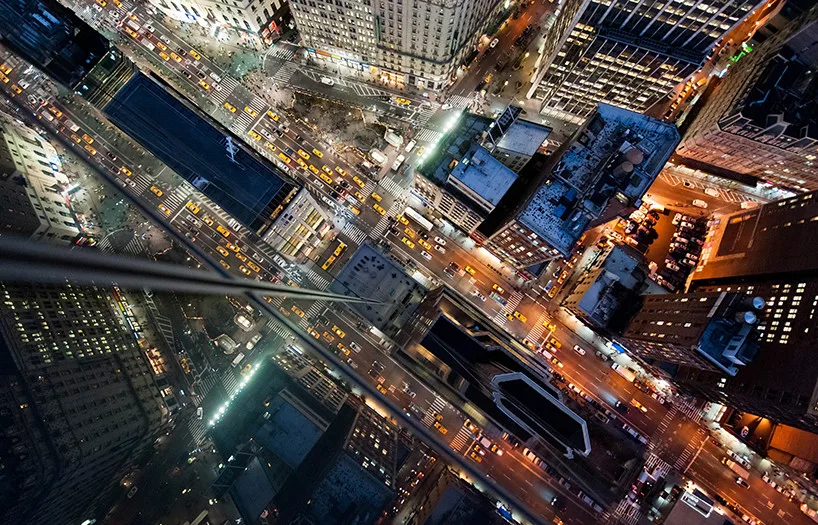 Reflections of urban skyline distorted on building glass surfaces.