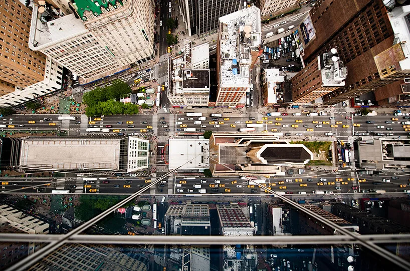 City buildings appear distorted through fractured reflections on glass.
