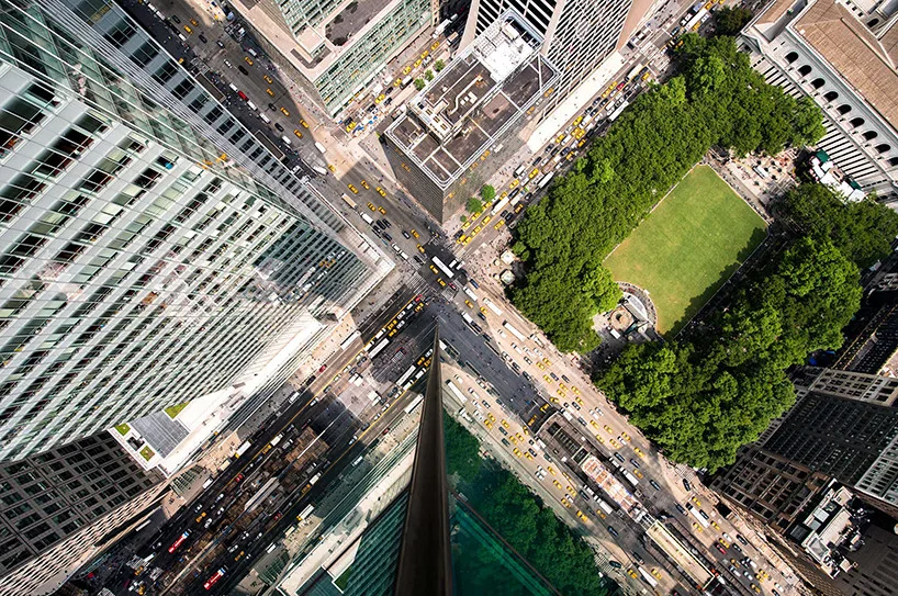 Multiple glass panels distort city reflections, creating a collage.