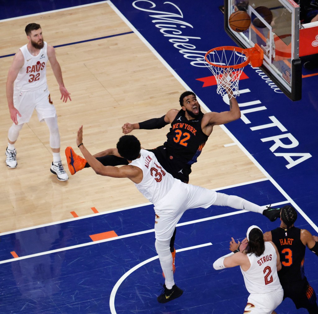 Karl-Anthony Towns drives to the basket against Cleveland Cavaliers center Jarrett Allen during the first quarter of game two of the eastern conference finals during the 2026 NBA playoffs at Madison Square Garden. 