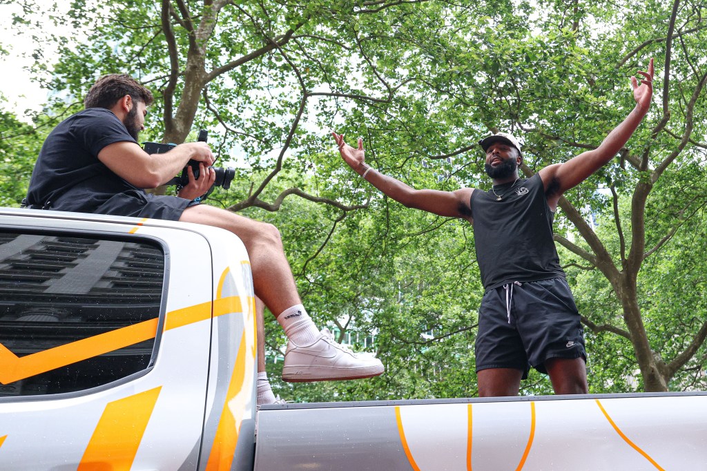 New York Knicks center Mitchell Robinson celebrating in a championship parade.