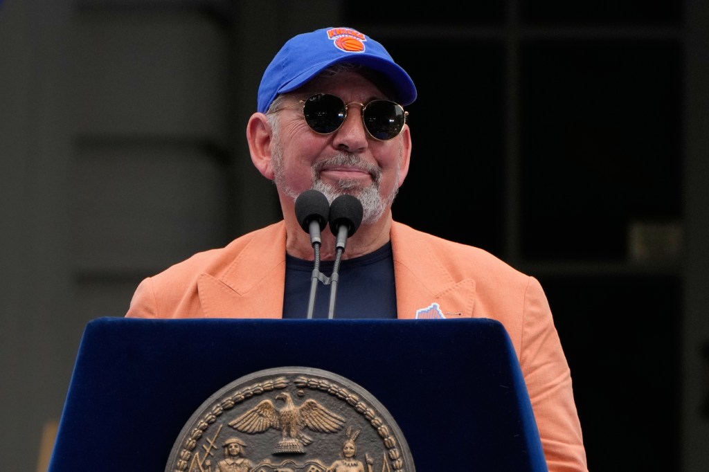 James Dolan, New York Knicks owner, speaks at a podium during the NBA championship parade.