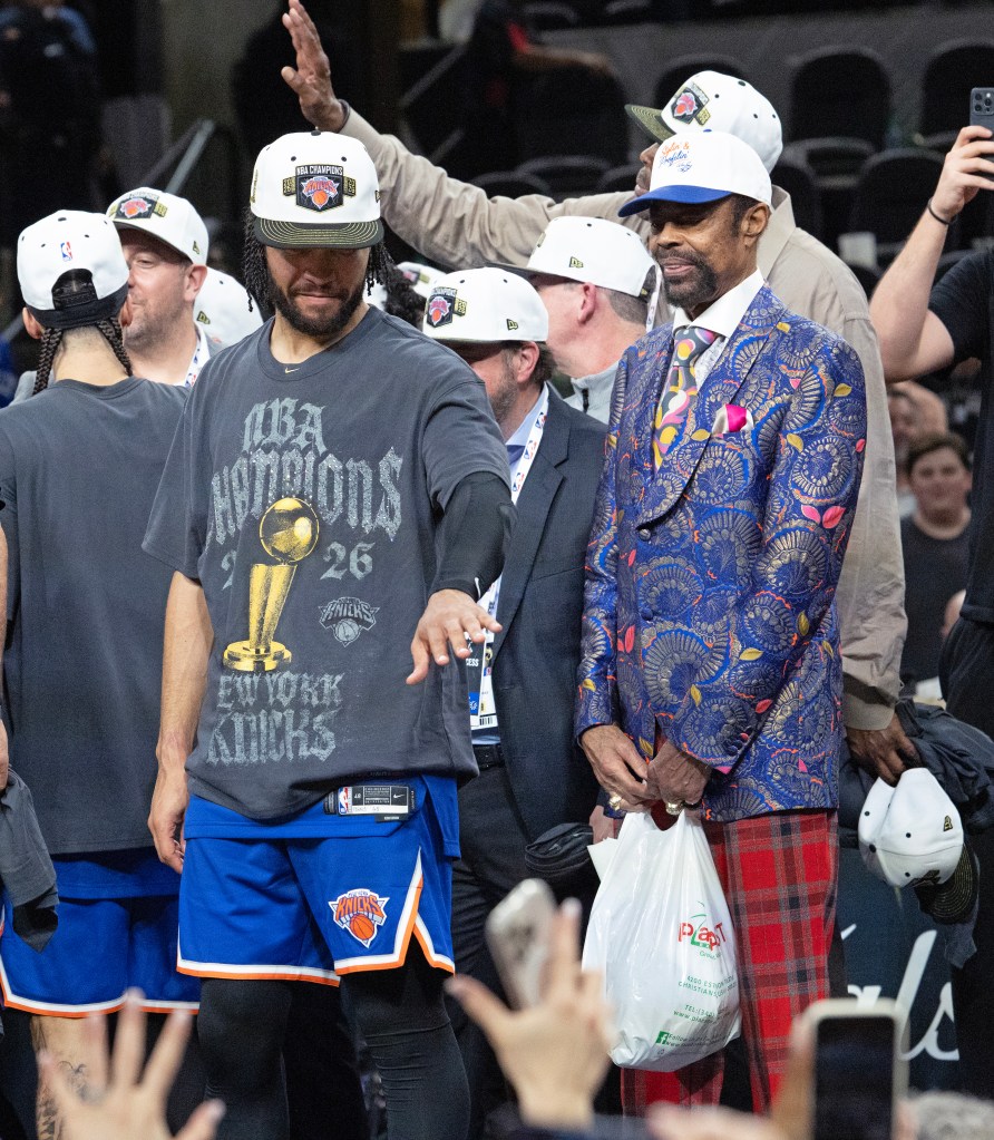 Knicks guard Jalen Brunson (l.) and legend Walt Frazier (r.) celebrate after the team's NBA championship win on June 13, 2026.