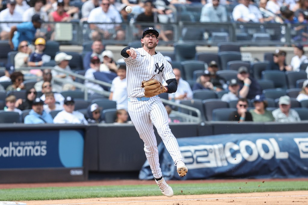 Yankees third baseman Ryan McMahon makes a throw to first against the Reds on June 21, 2026.