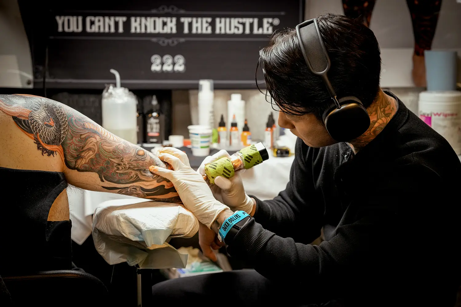 korean tattooer based in new york, shiryu, working on a colored neo japanese sleeve