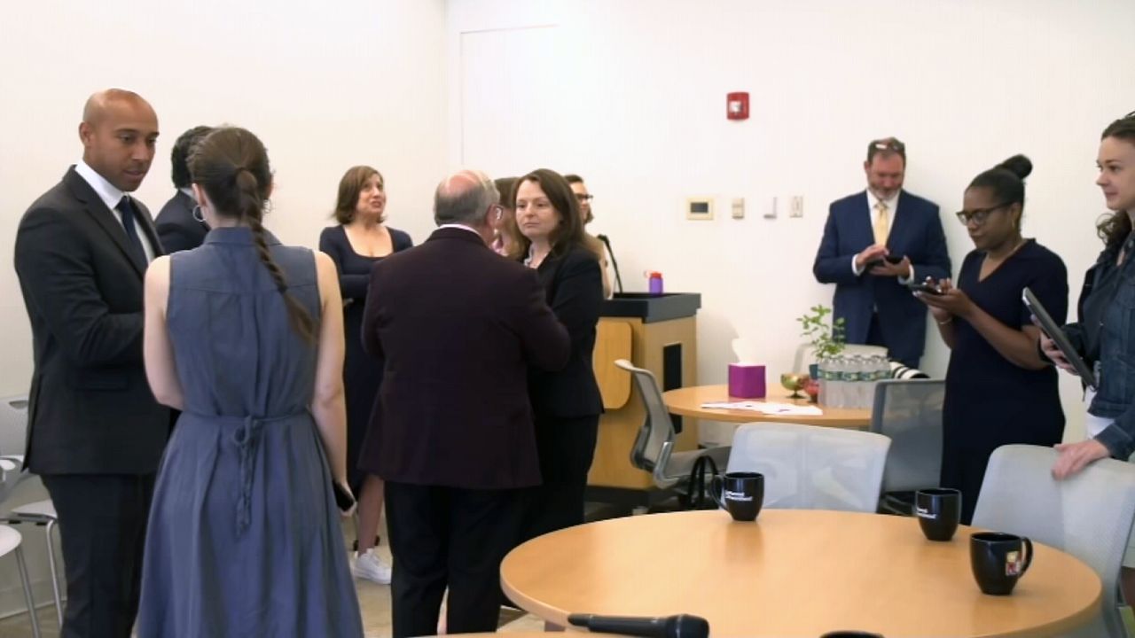 A photo of a group marking the expansion of the Abortion Access Hub.