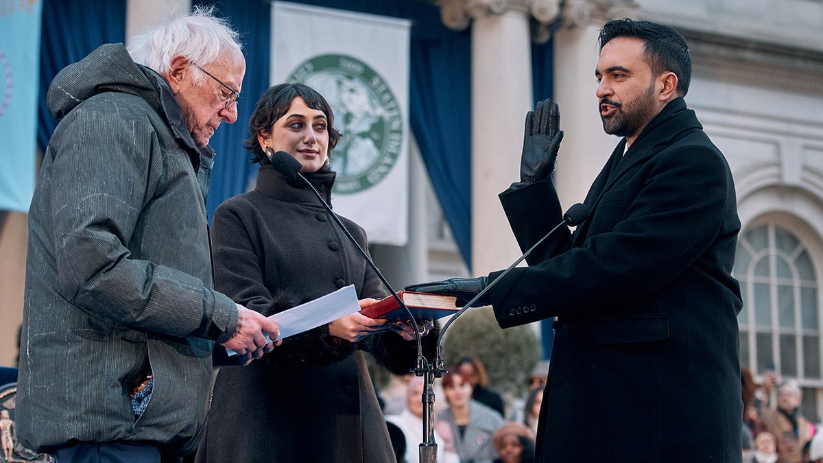 U.S. Sen. Bernie Sanders administering oath of office to Mayor Zohran Mamdani as Rama Duwaji holds Quran