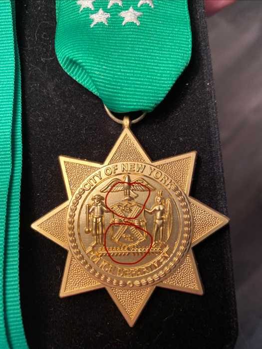 police medal with green ribbon