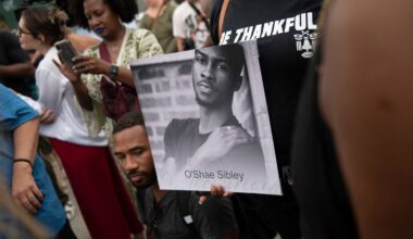 A person holds up a photo of O'Shae Sibley during a vigil at a gas station, Aug. 4, 2023, in the Brooklyn borough of New York. (AP Photo/Tracie Van Auken, File)