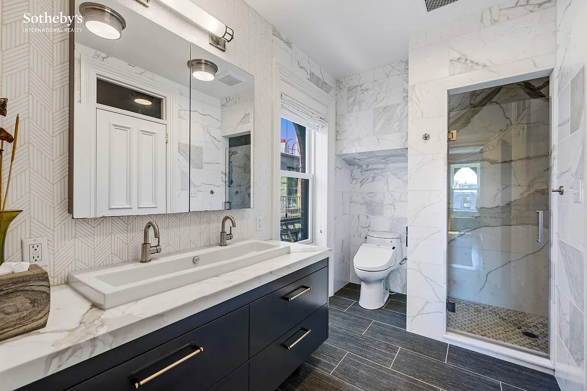 bathroom with double vanity, built-in shower
