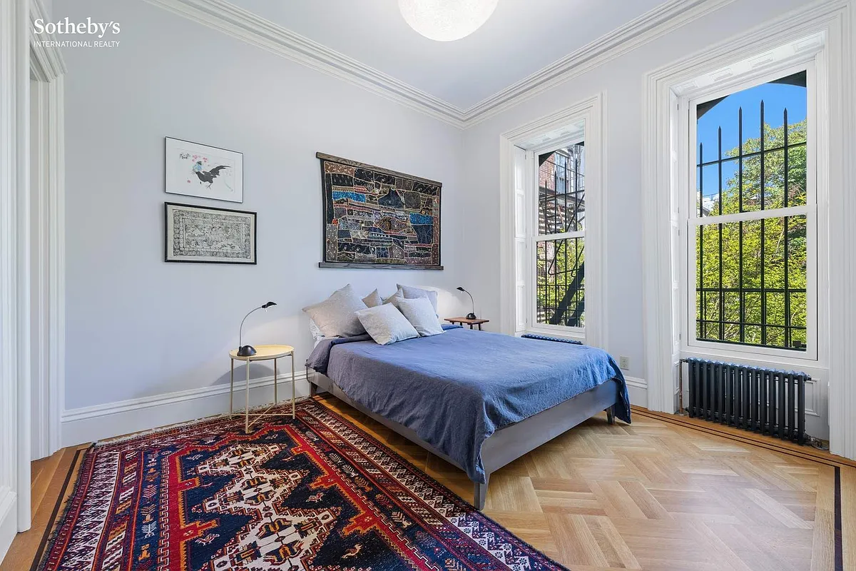 bedroom with blue walls, two windows