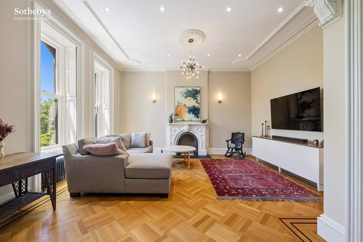 bedroom set up as a family room with wood floor, arched niche