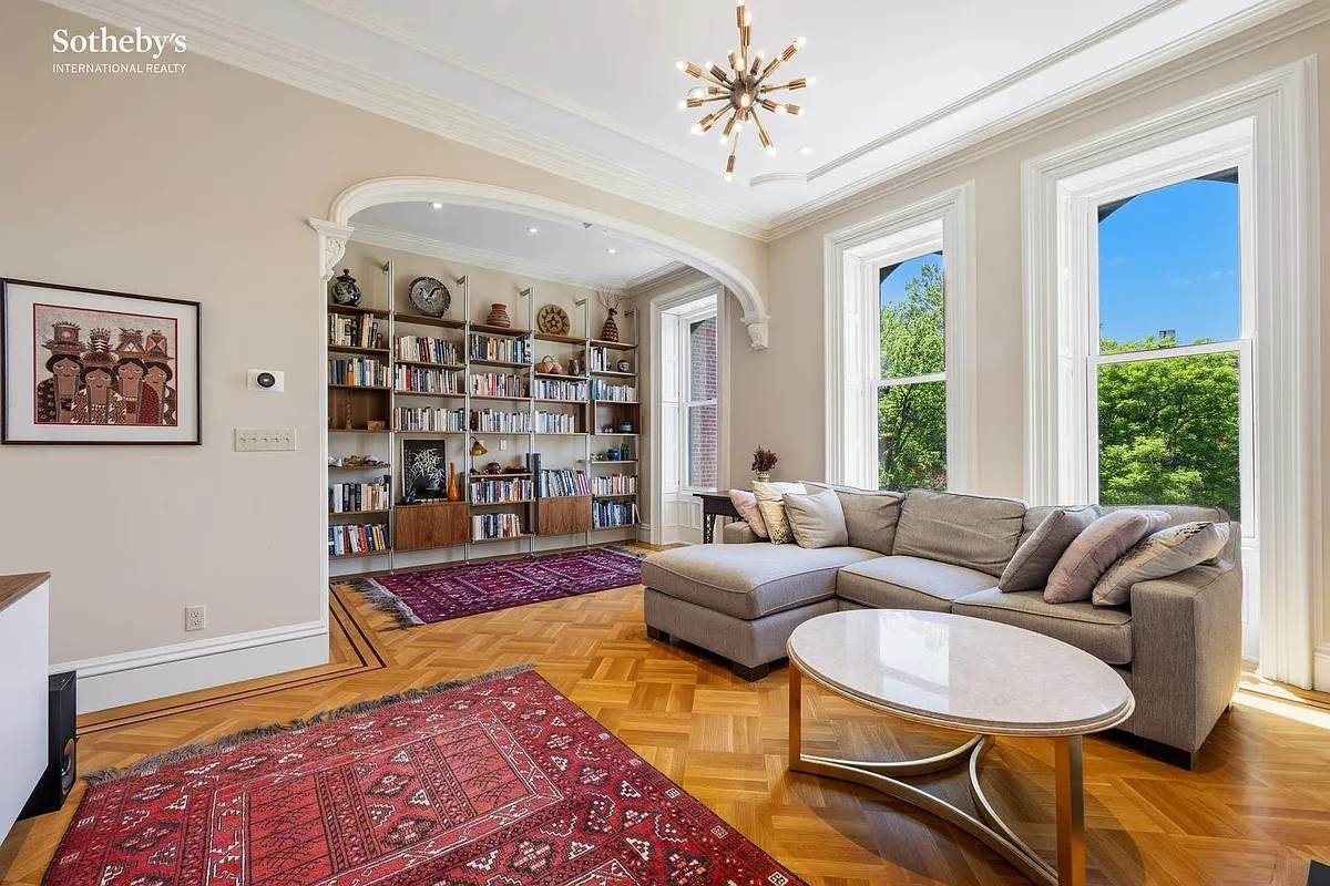 bedroom set up as a family room with wood floor, arched niche