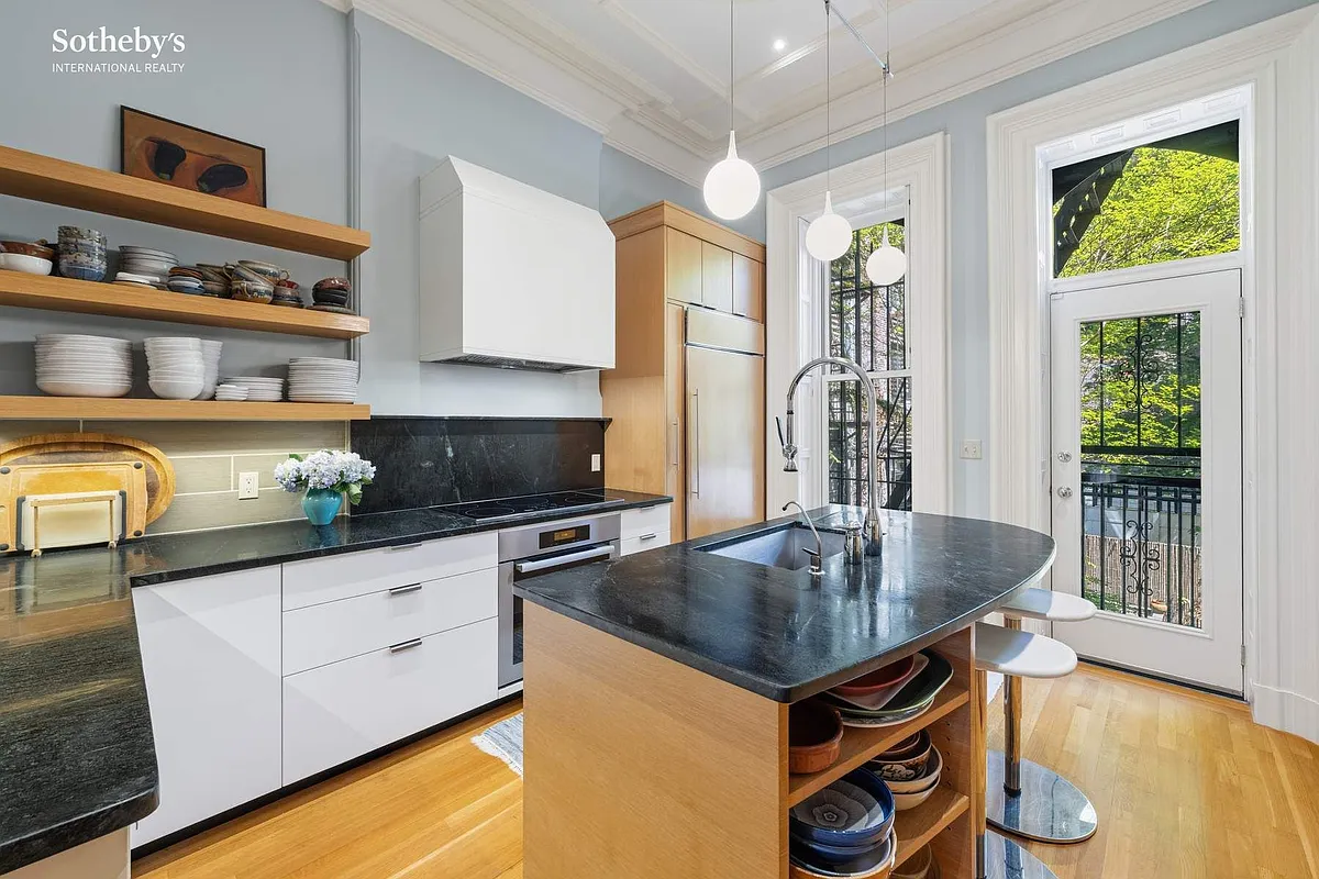 kitchen with curved island, mix of white and wood cabinets, open shelving