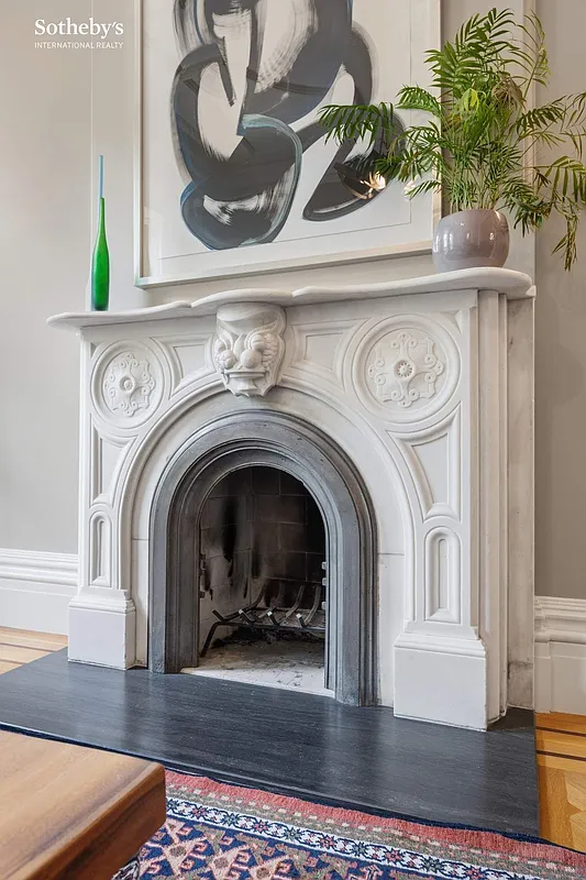 detail of a marble mantel with slab hearth