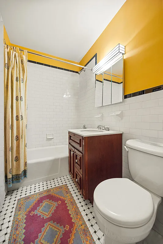 bathroom with black and white tiles, yellow walls
