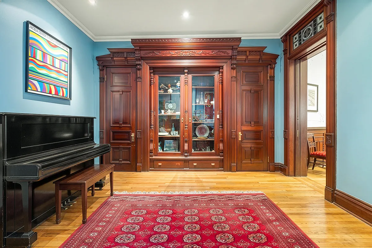 dining room with built-in china cabinet, stained glass transom