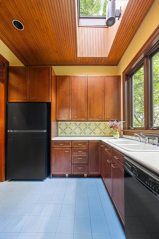 kitchen with wood cabinets, blue tile floor
