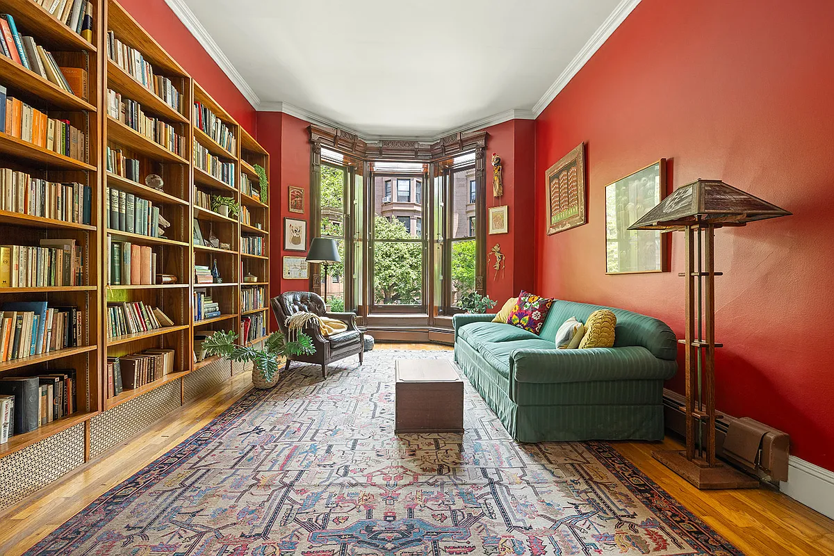 living room with red walls and angled bay