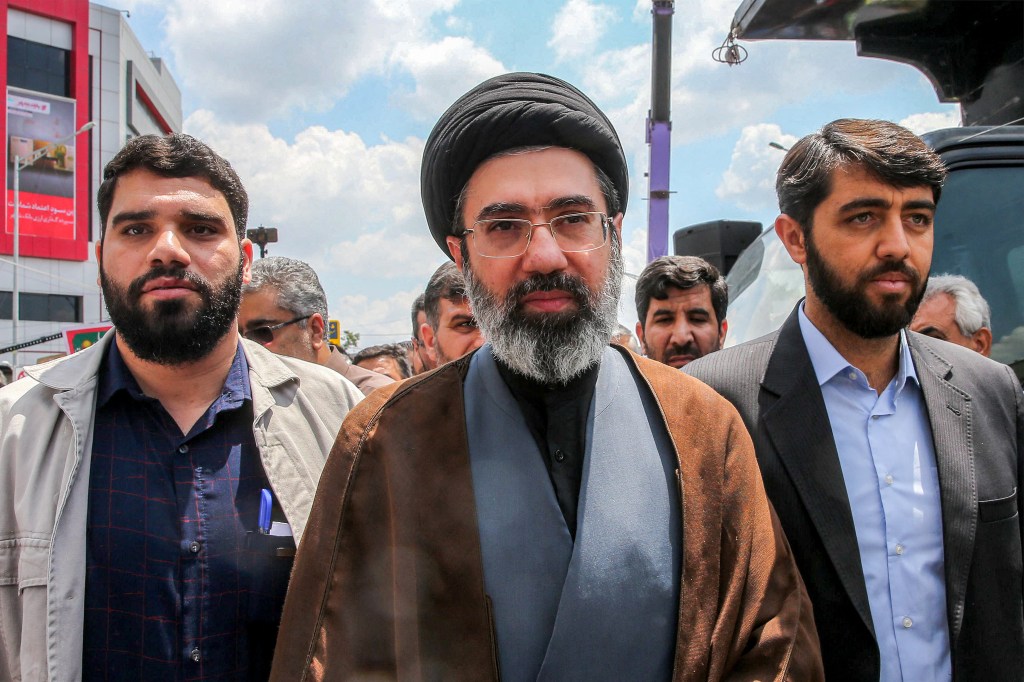 Mojtaba Khamenei walking down a street in Tehran.