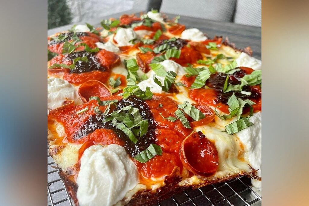 A pie at Bronx House Pizza with fresh basil, ricotta, and pepperoni.