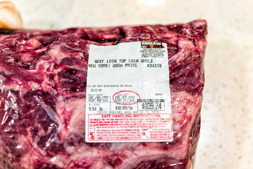 A vacuum-sealed package of Kirkland Signature beef top loin from Costco, with a sell-by date of May 17, 2022, and a price of $109.24.